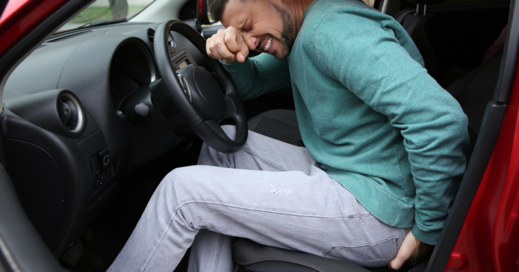 A man experiencing discomfort from a bed bug bite inside his car.