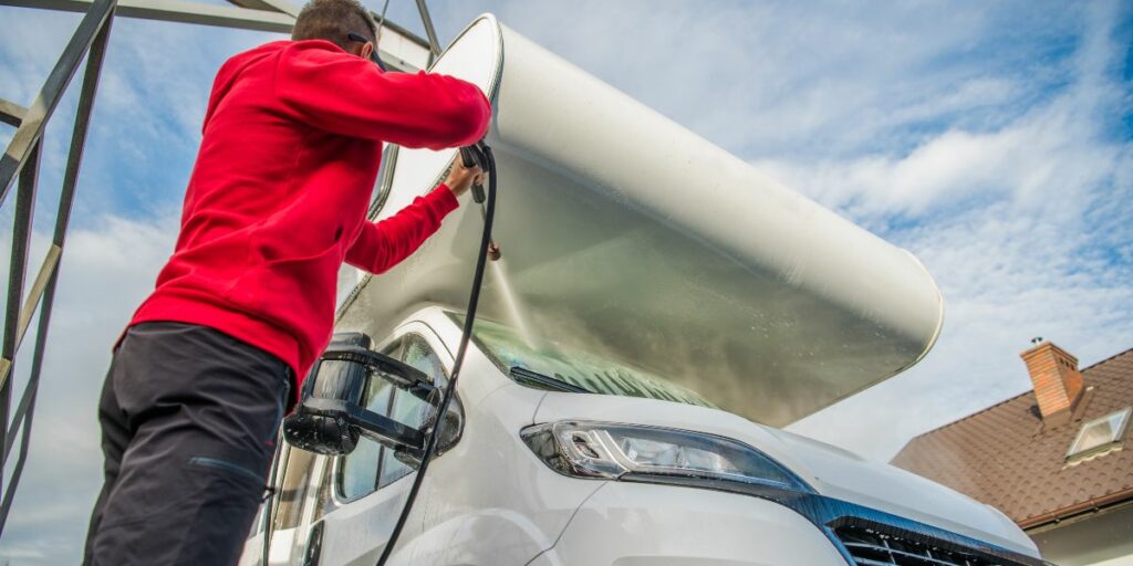 Take a look at a dedicated individual in full stride, diligently pressure-washing an RV to maintain its immaculate appearance.