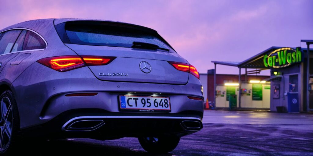 In this captivating image, a luxurious Mercedes SUV takes the spotlight as it stands confidently outside a service station.