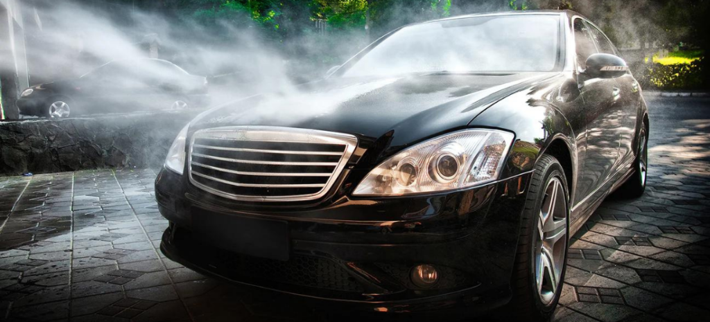 You see a striking black Mercedes car being treated to a rejuvenating spa day – a thorough and refreshing rinse using a combination of a high-pressure hose and an efficient pressure washer.