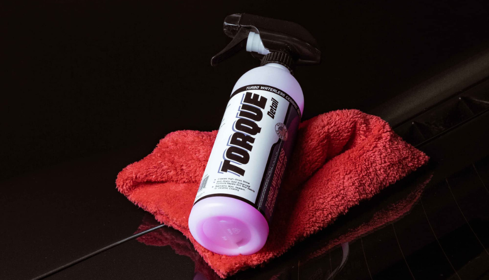 Featured is a bottle of Torque Detail's 'Plastic Restore,' a remarkably effective solution to clean and revitalize your Jeep Wrangler's soft top.