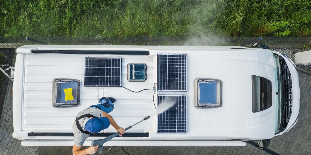 Here, we have a skilled RV detailer in action, expertly pressure washing a recreational vehicle's roof.