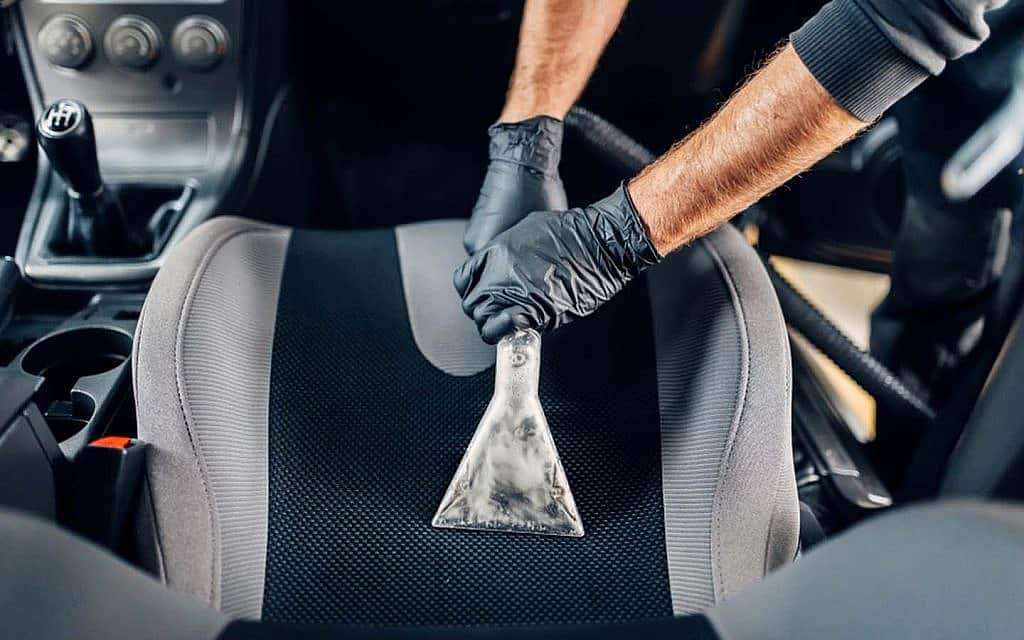 Vacuum cleaning car's upholstery.