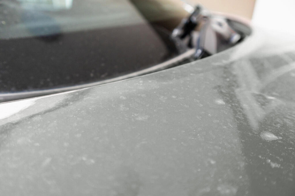 Water spots on the car's surface.